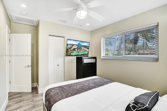 bedroom featuring a closet, wood finished floors, attic access, and recessed lighting