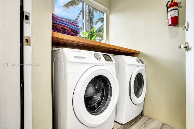 clothes washing area featuring laundry area, light wood-style floors, and independent washer and dryer