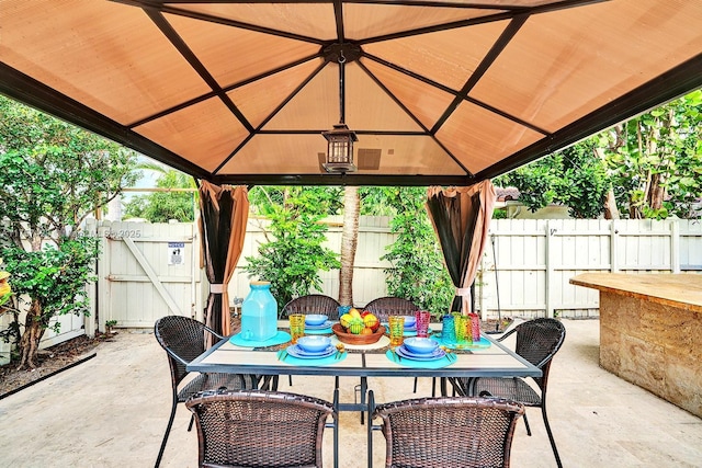 view of patio / terrace with fence and a gazebo