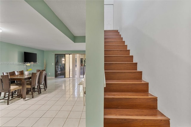 stairway featuring tile patterned flooring