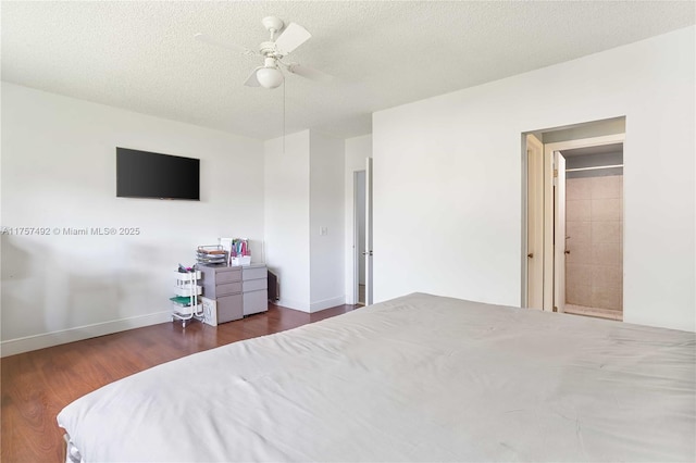 bedroom featuring ceiling fan, a textured ceiling, baseboards, and wood finished floors