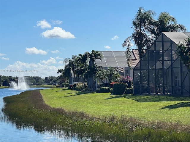 view of property's community featuring a lawn and a water view