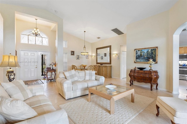 living room featuring arched walkways, high vaulted ceiling, a chandelier, light tile patterned flooring, and visible vents