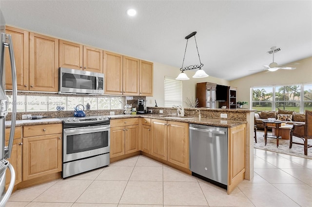 kitchen with stainless steel appliances, visible vents, a sink, and light brown cabinetry