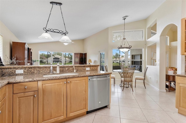 kitchen featuring lofted ceiling, dishwasher, a sink, and light tile patterned floors