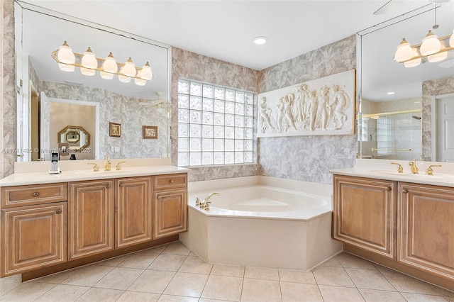 full bath featuring tile patterned floors, a sink, a shower stall, and wallpapered walls