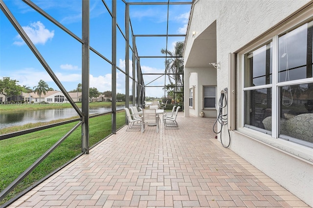 unfurnished sunroom featuring a water view