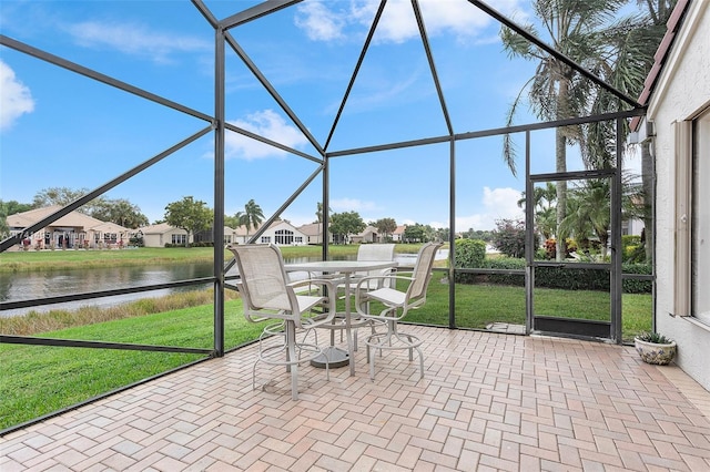 unfurnished sunroom featuring a water view