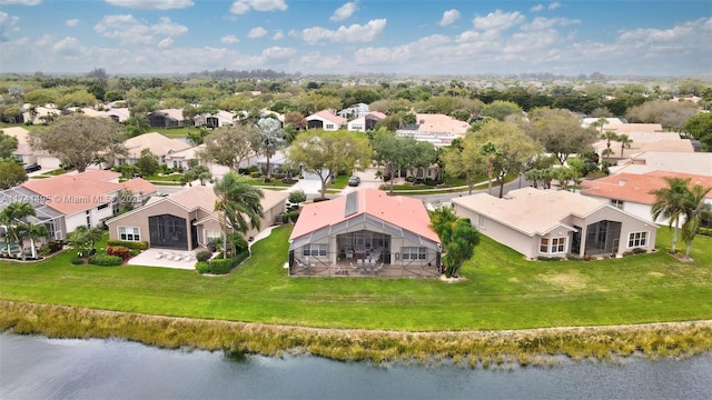 drone / aerial view with a water view and a residential view