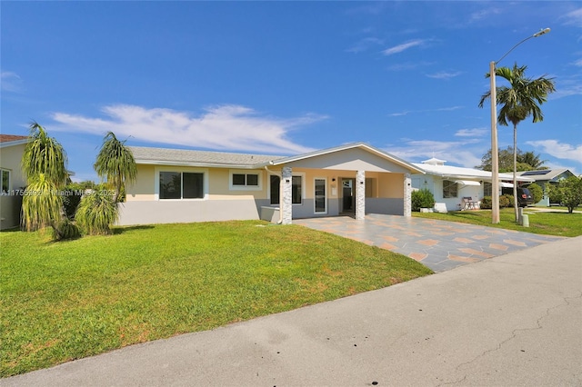 view of front of house with a front yard and stucco siding