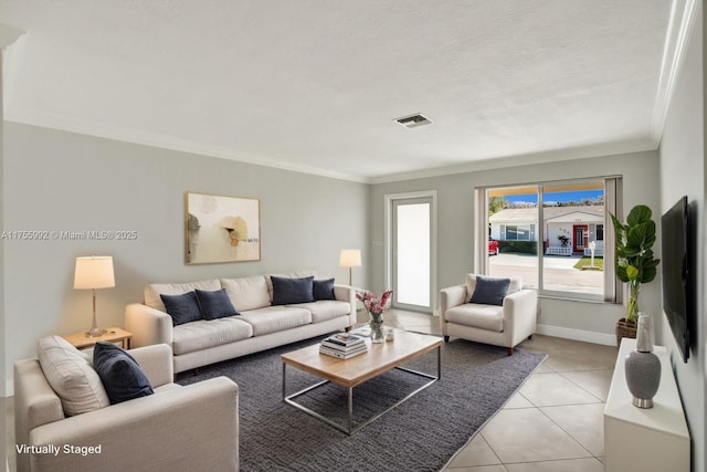 living area featuring light tile patterned floors, baseboards, visible vents, and ornamental molding