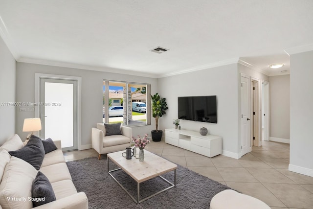 living area with light tile patterned floors, ornamental molding, visible vents, and baseboards