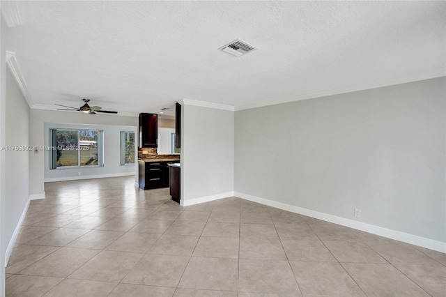 unfurnished living room with light tile patterned floors, visible vents, baseboards, ceiling fan, and crown molding