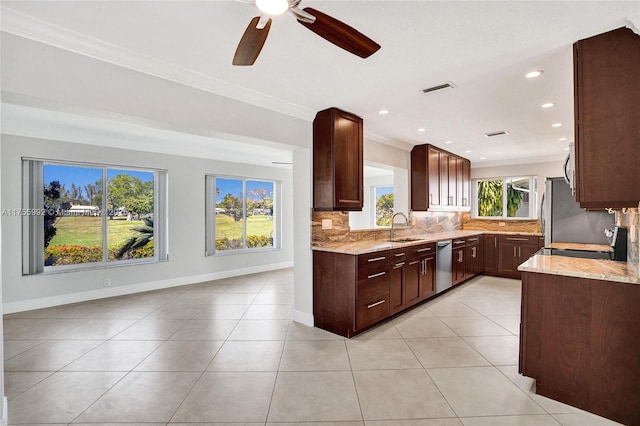 kitchen featuring light tile patterned floors, decorative backsplash, light stone counters, ornamental molding, and stainless steel appliances