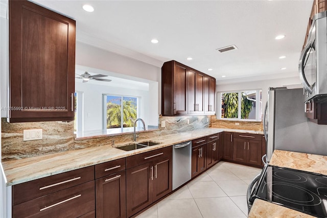 kitchen with visible vents, stainless steel appliances, a healthy amount of sunlight, a sink, and light tile patterned flooring