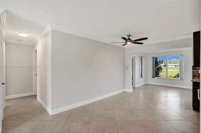 unfurnished room with light tile patterned floors, ornamental molding, a ceiling fan, and baseboards