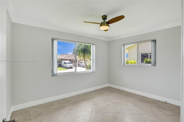 tiled empty room featuring ornamental molding, baseboards, and a ceiling fan