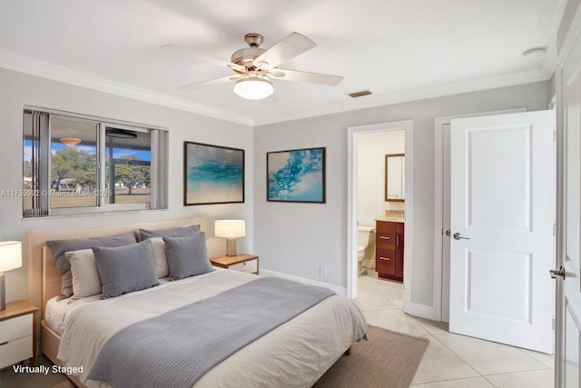 bedroom with light tile patterned floors, baseboards, visible vents, connected bathroom, and crown molding