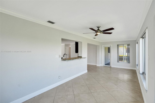 spare room with ornamental molding, light tile patterned flooring, visible vents, and baseboards