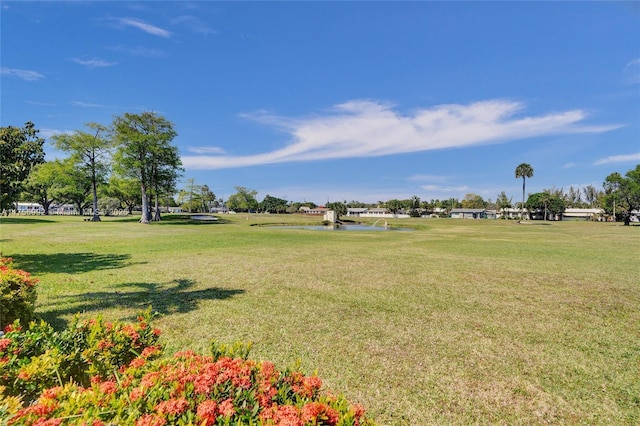 surrounding community with a lawn and a water view