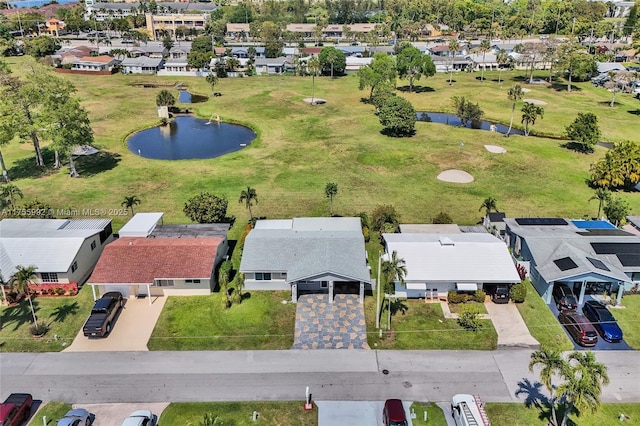 bird's eye view featuring a water view, view of golf course, and a residential view