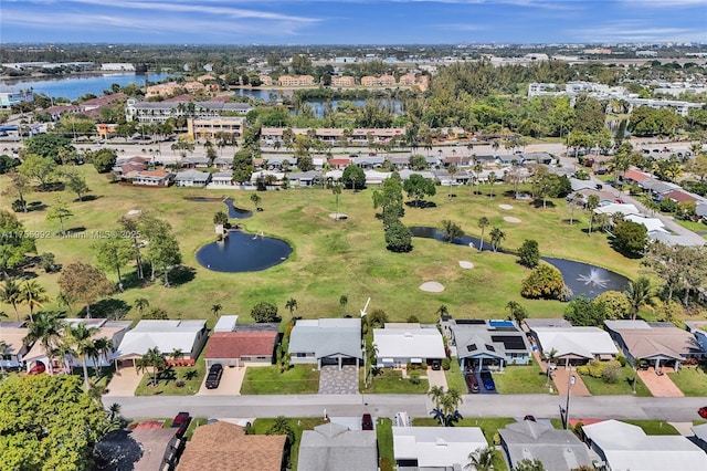 bird's eye view with a water view, a residential view, and golf course view