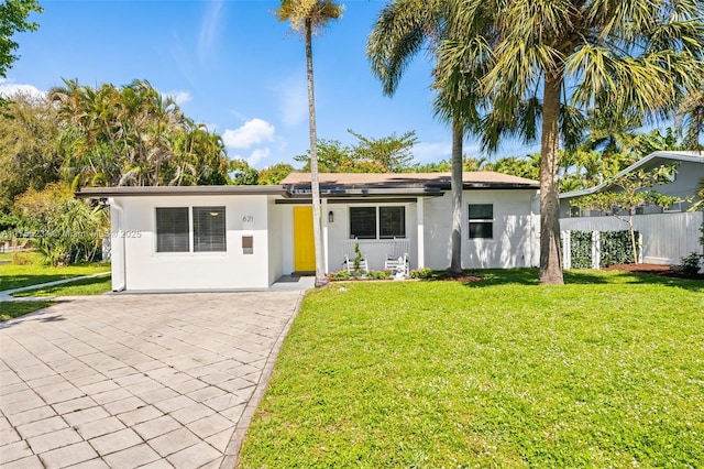 single story home featuring driveway, stucco siding, and a front yard