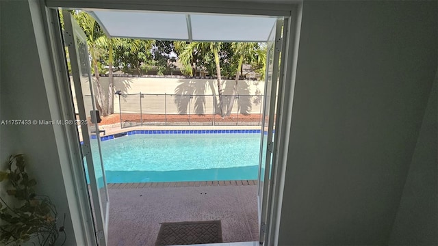 view of swimming pool featuring a fenced in pool and fence