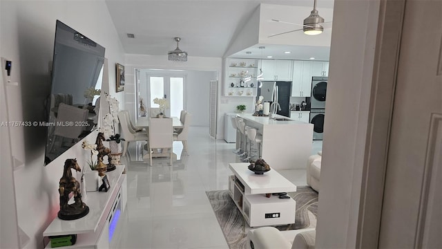 interior space featuring visible vents, stacked washer / drying machine, and french doors