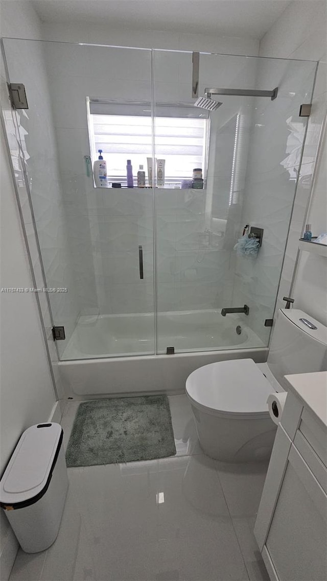 bathroom featuring vanity, toilet, and bath / shower combo with glass door