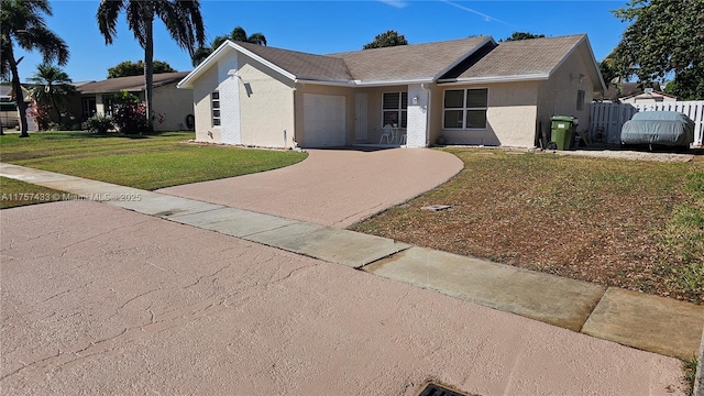 ranch-style house with a front yard, fence, an attached garage, stucco siding, and decorative driveway