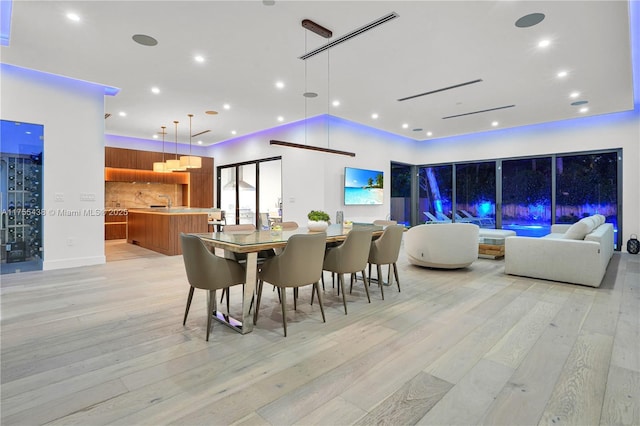 dining space with light wood-style floors and recessed lighting