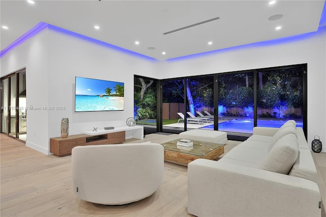 living area featuring visible vents, wood finished floors, and recessed lighting