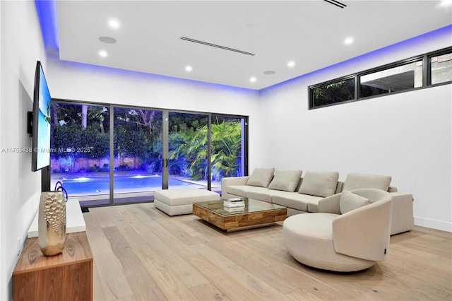 living room with wood finished floors and recessed lighting