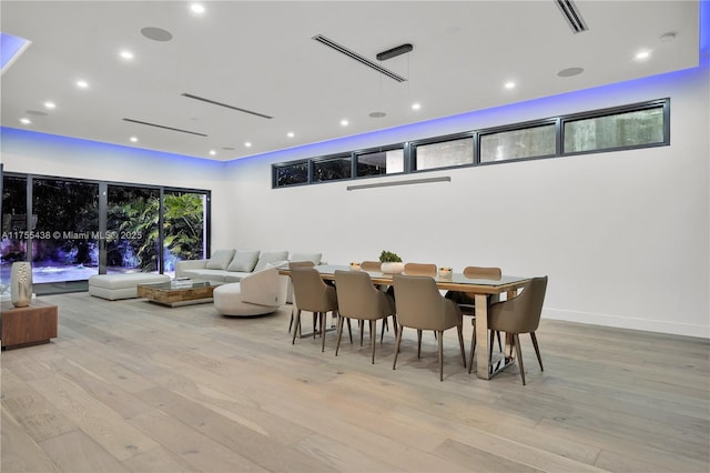 dining space featuring light wood-style floors, baseboards, visible vents, and recessed lighting