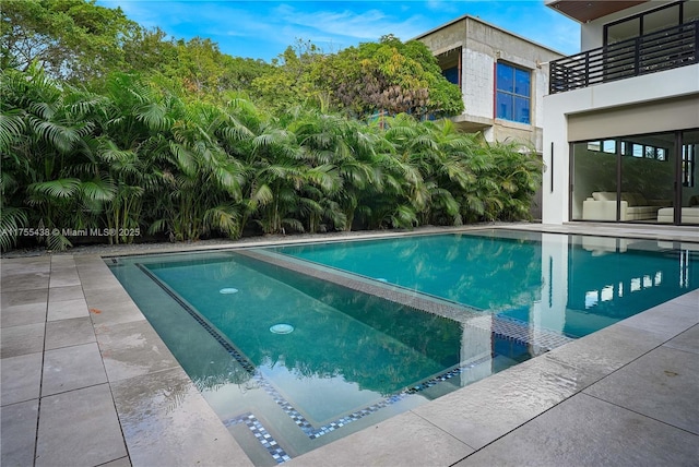 view of pool featuring a pool with connected hot tub and a patio