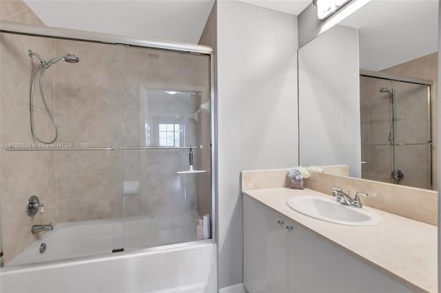 bathroom featuring enclosed tub / shower combo and vanity