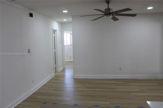 spare room featuring ceiling fan, recessed lighting, wood finished floors, and baseboards