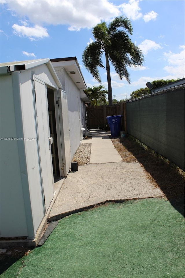 view of home's exterior with a patio area and fence