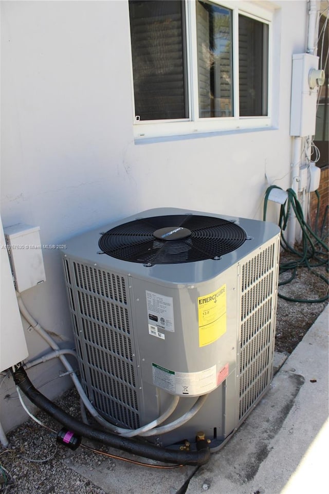 exterior details featuring electric meter and cooling unit