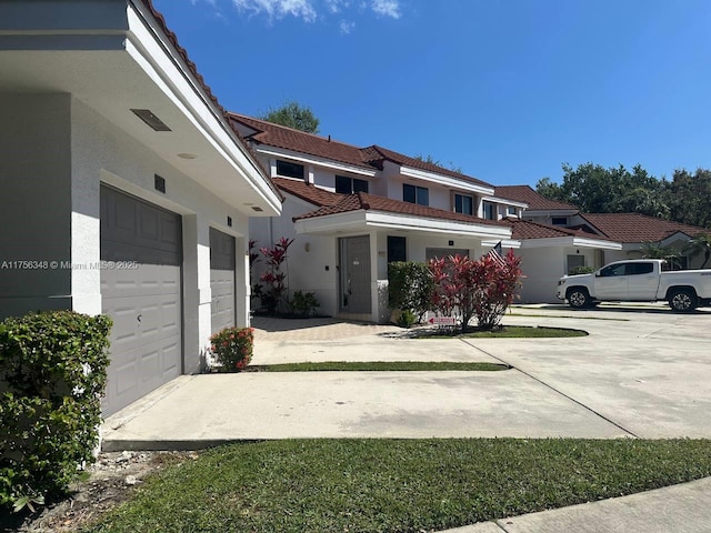 view of front of house with concrete driveway and stucco siding