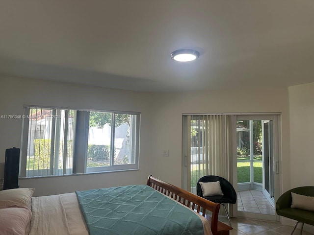 bedroom featuring tile patterned flooring and access to exterior