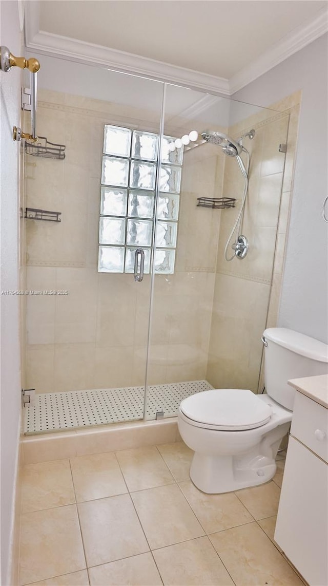 full bath with toilet, vanity, a shower stall, tile patterned floors, and crown molding