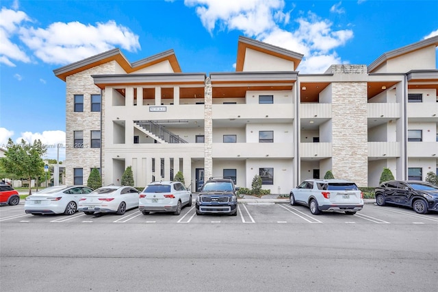 view of building exterior with uncovered parking