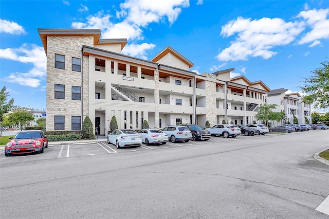 view of building exterior featuring uncovered parking