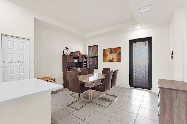 dining space with recessed lighting, a raised ceiling, visible vents, light tile patterned flooring, and baseboards