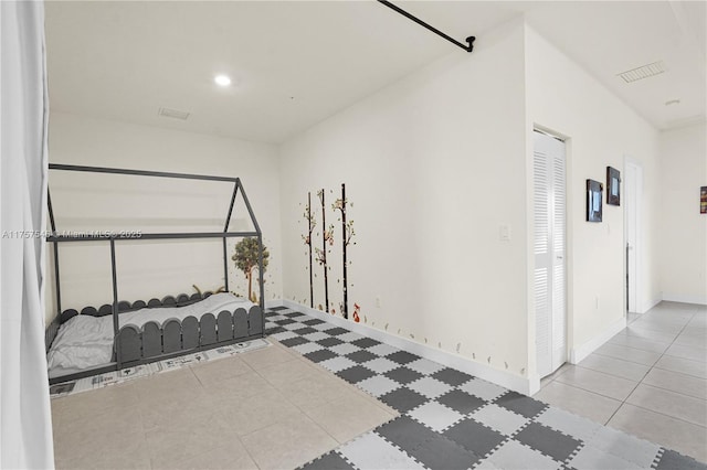 bedroom featuring visible vents and baseboards