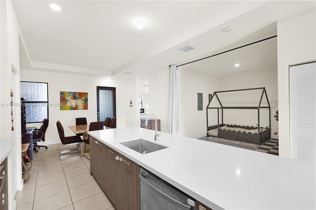 kitchen with light tile patterned flooring, a sink, visible vents, light countertops, and stainless steel dishwasher