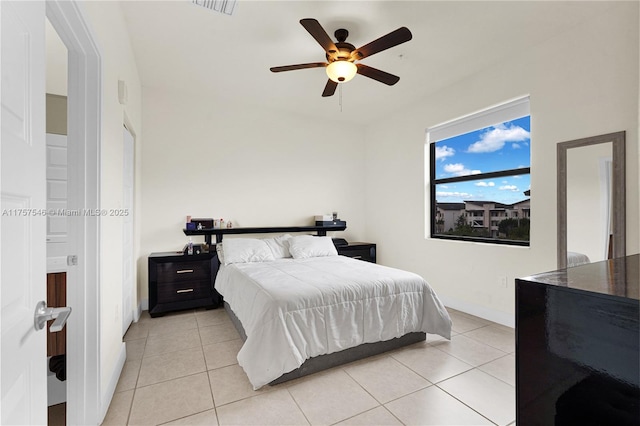 bedroom featuring a ceiling fan, visible vents, baseboards, and light tile patterned floors