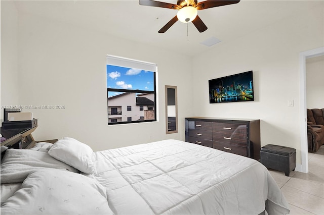 bedroom with light tile patterned floors, ceiling fan, and visible vents